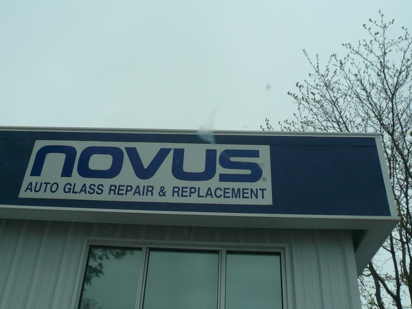 sign on building saying Novus Auto Glass Repair & Replacement
