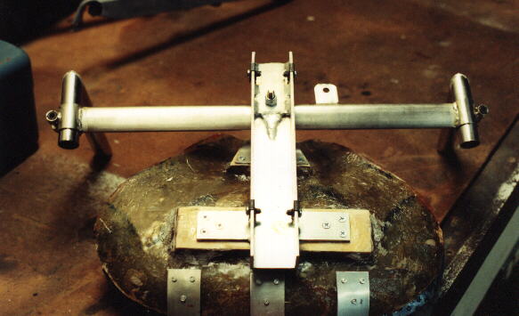 The bottom of the seat assembly for the Reynolds Wishbone recumbent was made out of wood, fiberglass, and metal parts.