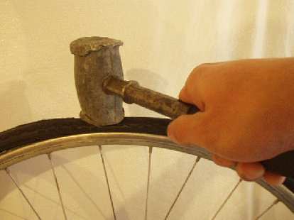 My technique of using a lead knock-off hammer seemed very effective in mounting the tire!