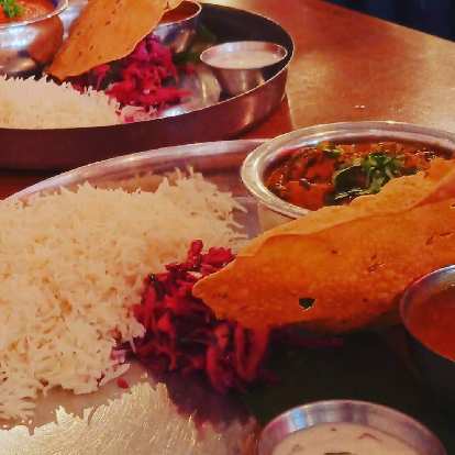 Photo: Saag Paneer and Chicken Thali with rice, slaw, and papadams at Chai Pani in Asheville.