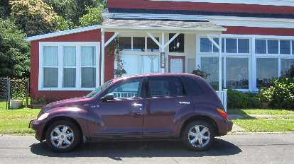 purple Chrysler PT Cruiser, red and white building, Paradise Gallery, Astoria, Oregon