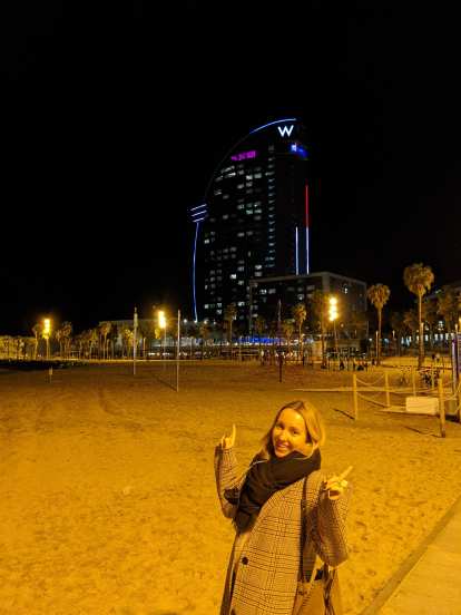 Andrea at the beach in front of the W Barcelona at night.