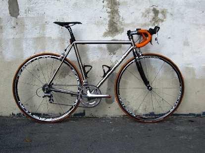 Titanium Merlin with orange handlebar tape.