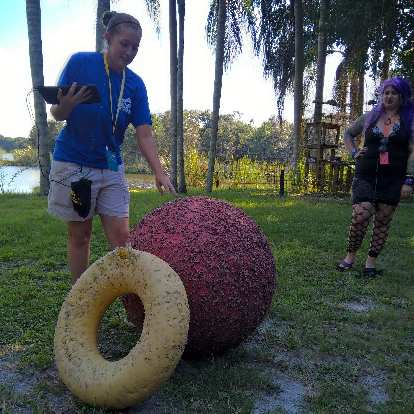 The tour guide showing some of the toys tigers play with. The ball was very heavy; I could not pick it up.