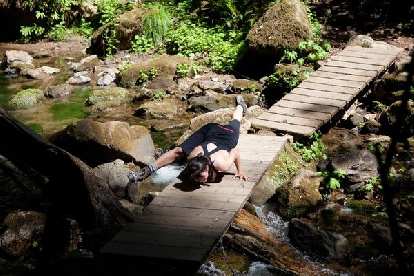 Alyssa doing a yoga pose on a bridge without falling into the river. Photo: Bryan O'Connor. Alyssa doing a yoga pose on a bridge without falling into the river.