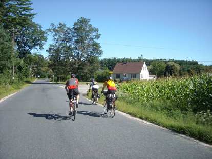 [Mile ~77] Riding past corn fields with Anthony, Ted, and Chip not far from the border of New Hampshire.