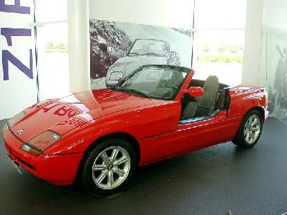 This is a 1989 BMW Z1 roadster (which started the "Z" designation for BMW roadsters).  Its distinctive feature were doors that retracted downward into the body work to allow egress and ingress.