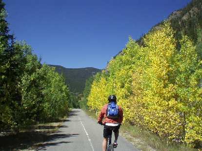 Mike riding along by aspen that has already begun to change colors.