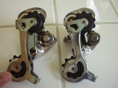 I was riding off-road (on my road bike, and a long piece of barbed wire got tangled in the rear wheel, seizing the wheel. When the wheel seized, the tension tab on the rear derailleur (Campagnolo Veloce, above right) broke off. (On the left is an identical, unbroken derailleur for comparison.) (12 Jun 2004) I was riding off-road (on my road bike, and a long piece of barbed wire got tangled in the rear wheel, seizing the wheel. When the wheel seized, the tension tab on the rear derailleur (Campagnolo Veloce, above right) broke off. (On the left is an identical, unbroken derailleur for comparison.)