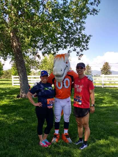 Raquel, Miles the Mascot, and Felix Wong after the 2017 Broncos 7k run in Fort Collins.