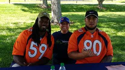 Raquel with Denver Broncos linebacker Vontarrius Dora and nose tackle Kyle Peko.