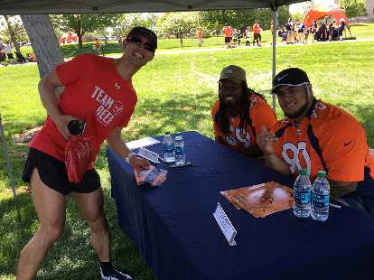 Felix Wong with Denver Broncos linebacker Vontarrius Dora and nose tackle Kyle Peko.