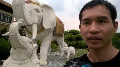 Felix Wong with elephant statues at the Buddha Memorial Center in Taiwan.