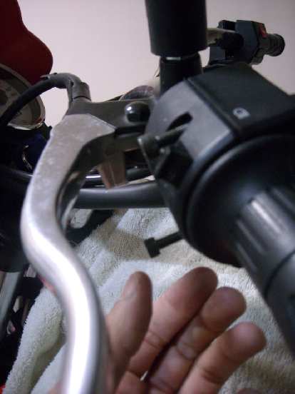 Removing the two SAE screws to detach the assembly for the turn signals, horn and lights from the handlebars. Removing the two SAE screws to detach the assembly for the turn signals, horn and lights from the handlebars.