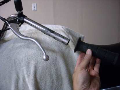 Removing the left grip from the handlebars. Removing the left grip from the handlebars.