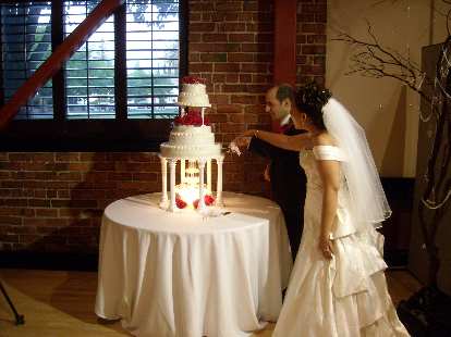 Trang and Naoum cut their wedding cake. Trang and Naoum cut their wedding cake.