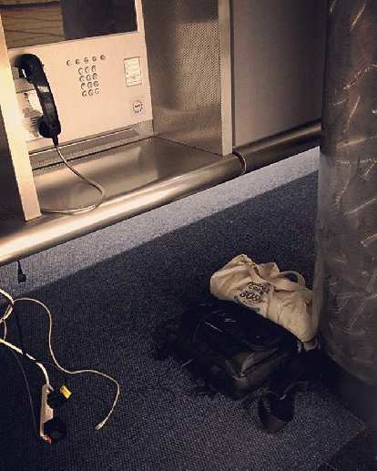 My flight arrived at the Denver airport late and I missed the last shuttle. So I slept underneath this telephone booth at the airport for a few hours. telephone booth, floor underneath, Denver International Airport