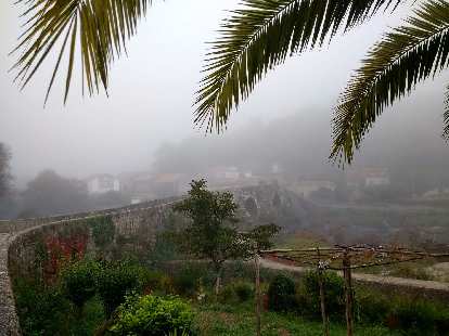 Fog over a bridge overlooking a river along the Camino de Fisterra.