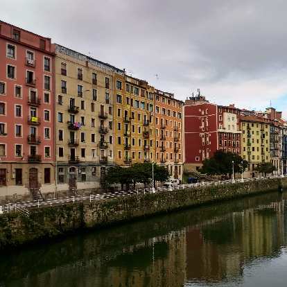 Colorful buildings by the Nervión River in Bilbao, Spain.
