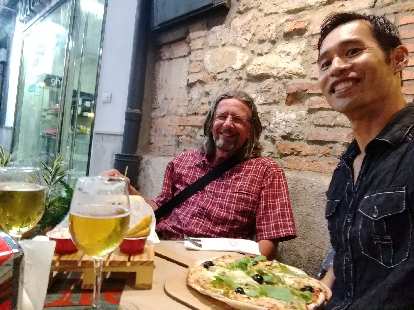 Thomas H. from Germany and Felix Wong at Fun & Food Ocio Gastronomico, for pizza and beer, in Santander, Spain.