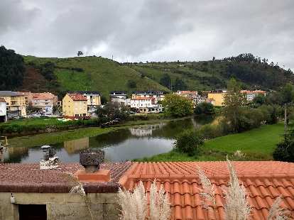 Homes and a river in Bustio, Spain.