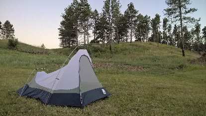 My white and blue Sierra Designs Clip Flashlight CD (vintage 1999) tent at Chadron State Park. Photo: White and blue Sierra Designs Clip Flashlight CD tent, grass, pine trees, Chadron State Park.