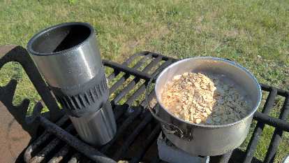 I made oatmeal for breakfast on my Nesbitt solid fuel stove. Photo: thermal cup, oatmeal in aluminum camping pot, Nesbitt stove