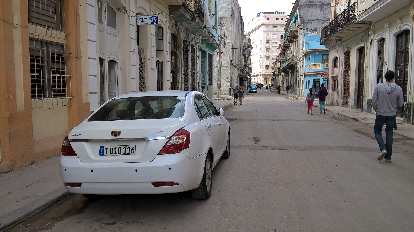 A newish white Geeley EC7 sedan in Havana, Cuba.