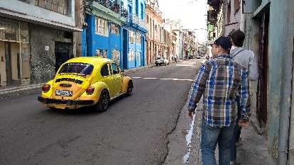 Yellow 1970s Volkswagen bug in Havana, Cuba.