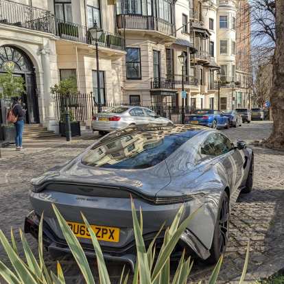 A grey Aston Martin near Hyde Park in London.