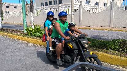 Four Mexicans including two kids on a Batman motorcycle in Isla Mujeres. (17 Nov 2015) four Mexicans including two kids on a Batman motorcycle, Isla Mujeres