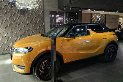A yellow DS 3 Crossback inside the the DS Automobiles showroom on Rue François 1er.