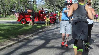 Red firetruck, firewoman, shirtless fireman