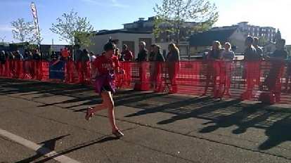 Maureen running in the final stretch of the Colorado Marathon 10k. Maureen running in the final stretch of the Colorado Marathon 10k, red shirt, Team Beef