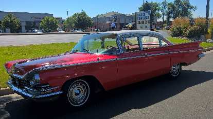 A red 1960s Cadillac sedan.