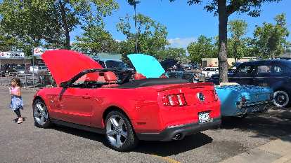 A red 2011 Ford Mustang convertible with a 1966 Columbine blue High Country Special Ford Mustang convertible.