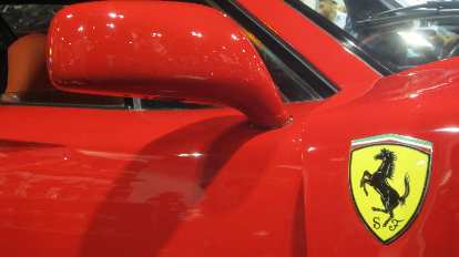 yellow Ferrari badge on red Ferrari F40