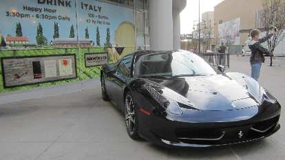 A black Ferrari 458 Italia in front of Drink Italy with a selfie enthusiast. black Ferrari 458 Italia, Drink Italy, selfie enthusiast