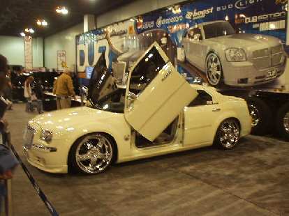 Snoop Dogg's custom Chrysler 300C with "Lambo doors" and "seats that took 7 hours to stitch by hand" was on display.  What a waste.