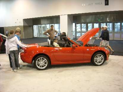 An orange-red Mazda MX-5, Leah's favorite car of the show. An orange-red Mazda MX-5, Leah's favorite car of the show.