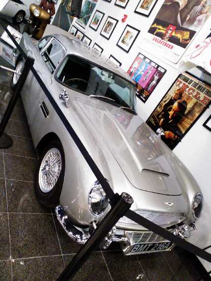 The classic James Bond Aston Martin DB5. You can see the rear tire slicer, machine guns poking out the front and extending overriders. The classic James Bond Aston Martin DB5. You can see the rear tire slicer, machine guns poking out the front and extending overriders.