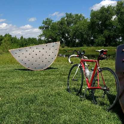 Red Cannondale 3.0 in front of watermelon art at Cottonwood Glen Park in Fort Collins, Colorado.