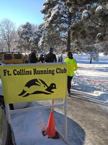 Fort Collins Running Club yellow sign, finishing chute, Edora Park 8k