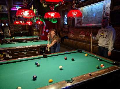 Morgan shooting pool for only her third time at the Trail Head Tavern.