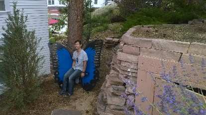 Felix Wong on a blue butterfly bench outside the Stanley Hotel. Felix Wong on a blue butterfly bench outside the Stanley Hotel.
