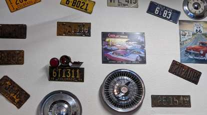 License plates, hubcaps, and Route 66 posters on the wall at Penelope's Hamburgers & Fries.