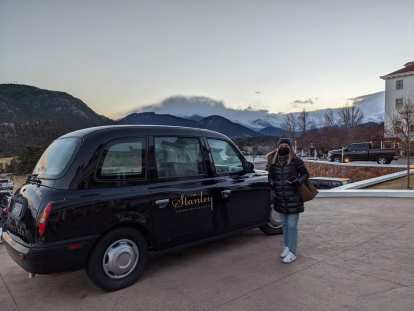 Andrea with a black London taxi outside the Stanley Hotel.