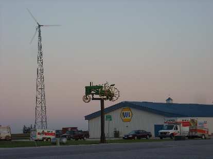 A windmill and lawn tractor by a Napa Auto Parks store not too far from Des Moines, Iowa. (11 Aug 2011) A windmill and lawn tractor by a Napa Auto Parks store not too far from Des Moines, Iowa.