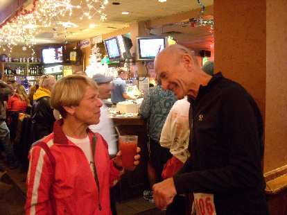 Cathy, forever young, won a pie for winning her age group. Here she is talking with a friend.