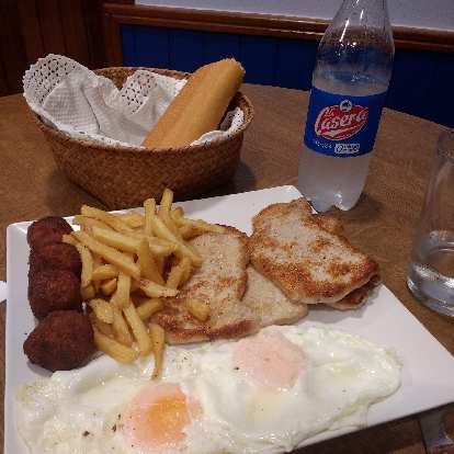Menú del día with eggs, meat balls, pork chops, french fries, and bread.  I also had a limonada gaseosa (kind of like a Sprite).